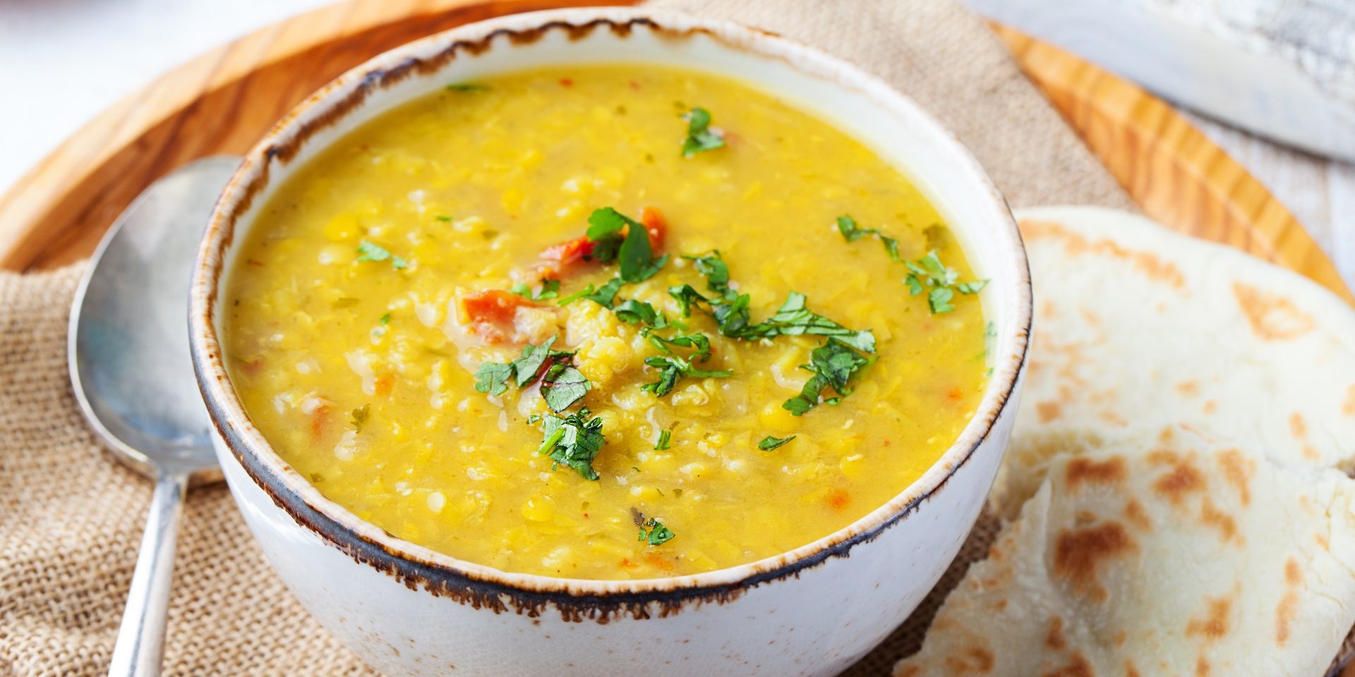 lentil-soup-with-pita-bread-in-white-bowl-on-a-woo-2021-08-26-16-29-55-utc-ok